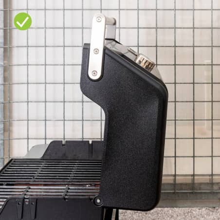 A gas grill with a squared lid that swings open wide.  